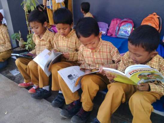 Anak Anak kelas 3 SDN 1 Purwasari sedang membaca buku di depan kelas